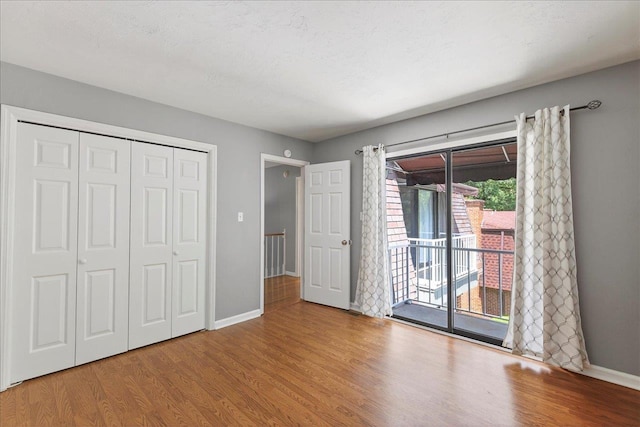 2965 N Shamrock, Tallahassee, FL 32309 - unfurnished bedroom featuring access to outside, wood finished floors, and a closet