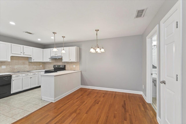 2965 N Shamrock, Tallahassee, FL 32309 - kitchen with black appliances, under cabinet range hood, decorative backsplash, white cabinets, and light countertops