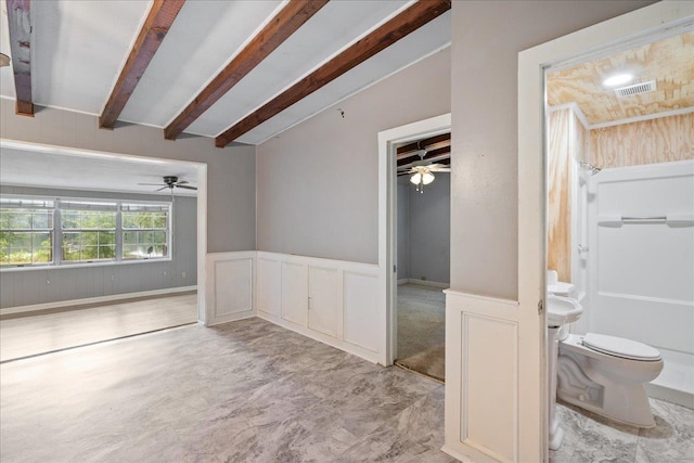 empty room with lofted ceiling with beams
