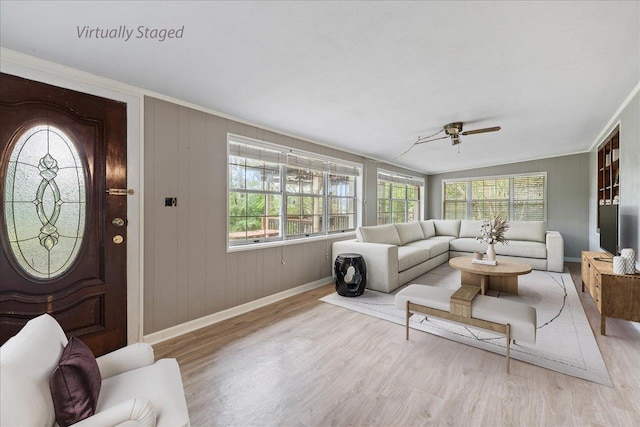living room with ornamental molding, light hardwood / wood-style flooring, lofted ceiling, and ceiling fan