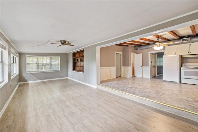 unfurnished living room featuring light hardwood / wood-style floors, ceiling fan, and beam ceiling
