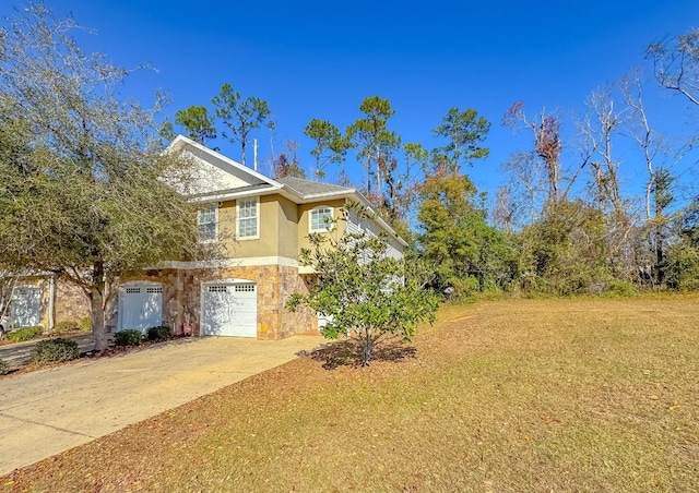 view of front of home with a garage and a front lawn