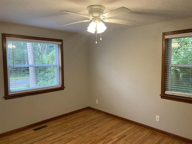 1915 Sunset Ln, Tallahassee, FL 32303 - empty room with healthy amount of natural light, light wood-type flooring, and a ceiling fan