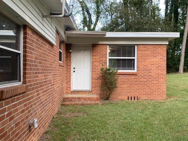 1915 Sunset Ln, Tallahassee, FL 32303 - doorway to property with a yard and brick siding