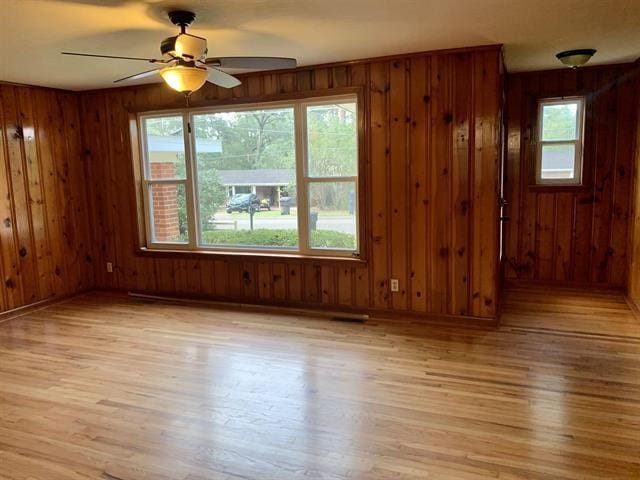 1915 Sunset Ln, Tallahassee, FL 32303 - spare room featuring light wood finished floors, wooden walls, and a ceiling fan