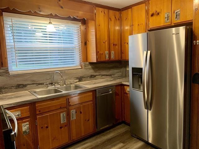 1915 Sunset Ln, Tallahassee, FL 32303 - kitchen with stainless steel appliances, brown cabinets, light countertops, and wood finished floors