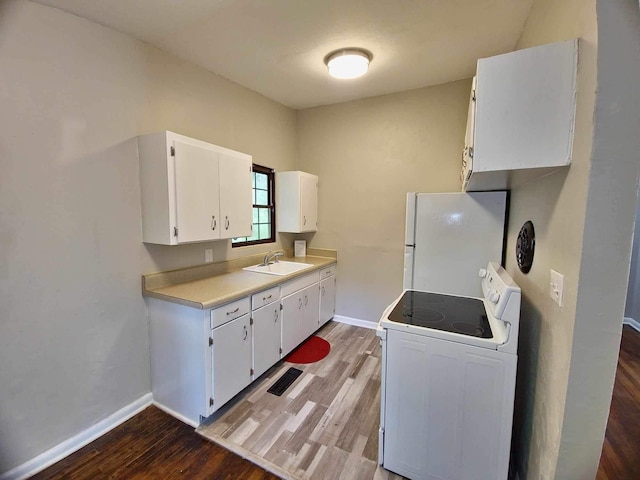 2031 Holmes St, Tallahassee, FL 32310 - kitchen featuring light countertops, white cabinetry, a sink, wood finished floors, and white appliances