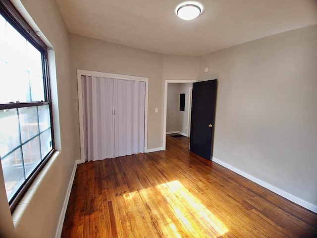 2031 Holmes St, Tallahassee, FL 32310 - unfurnished bedroom with a closet, baseboards, and wood finished floors