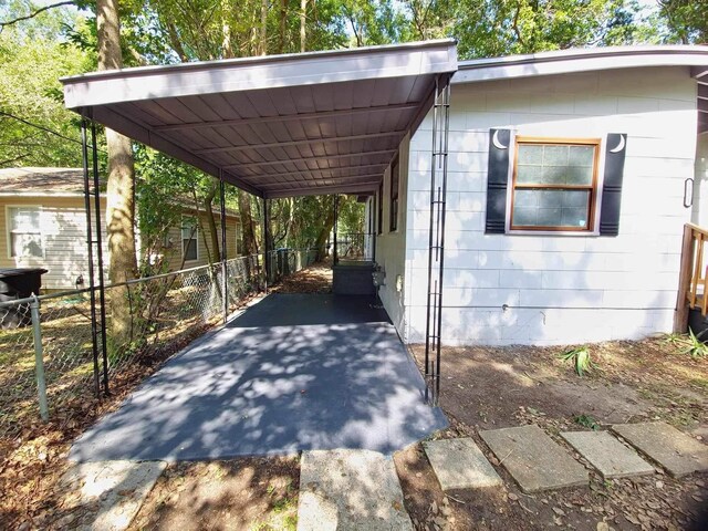 2031 Holmes St, Tallahassee, FL 32310 - view of vehicle parking featuring an attached carport and fence