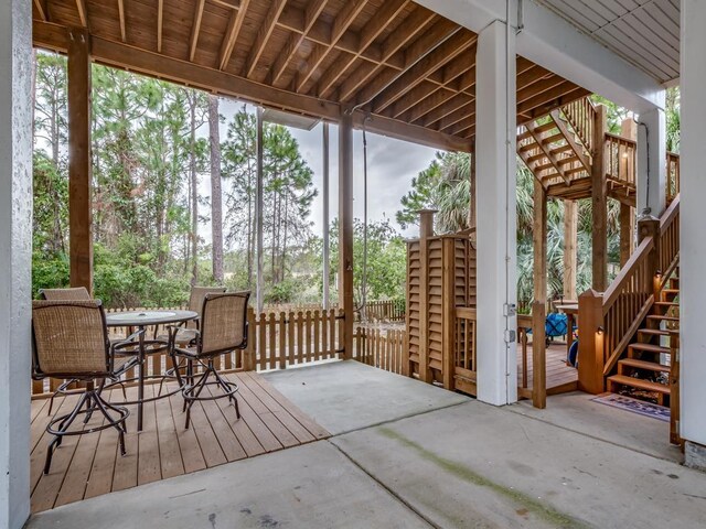 641 Bald Point Rd, Alligator Point, FL 32346 - wooden terrace with stairway, outdoor dining area, and a patio area