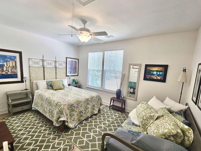bedroom featuring ceiling fan, baseboards, and visible vents