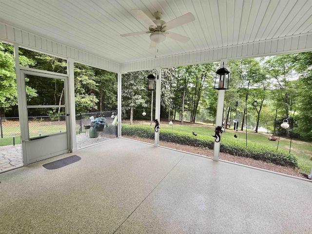 unfurnished sunroom with a ceiling fan