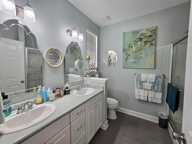 full bathroom with a shower stall, toilet, and a sink