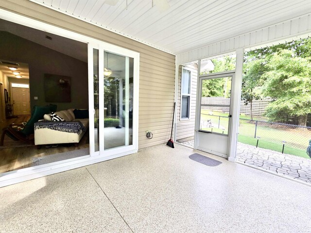 sunroom / solarium with a ceiling fan