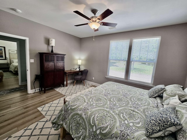 bedroom featuring ceiling fan, baseboards, wood finished floors, and visible vents