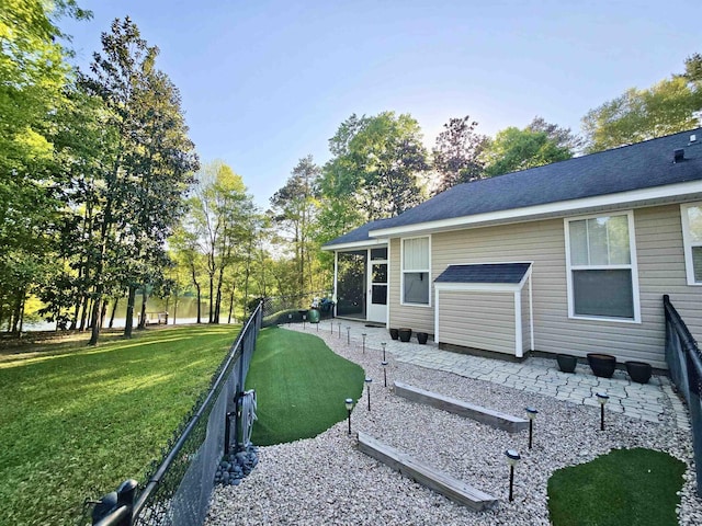 rear view of house with a patio area, fence private yard, and a yard