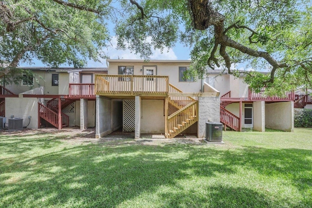 1317 Airport Dr Unit F12, Tallahassee, FL 32304 - rear view of property featuring stairway, a yard, a wooden deck, and stucco siding