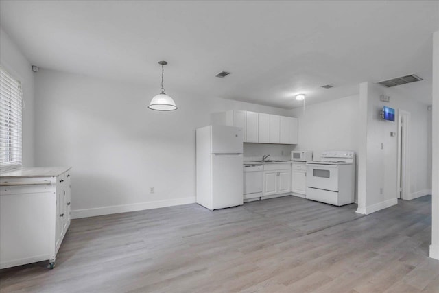 1317 Airport Dr Unit F12, Tallahassee, FL 32304 - kitchen featuring white appliances, visible vents, a sink, and light countertops