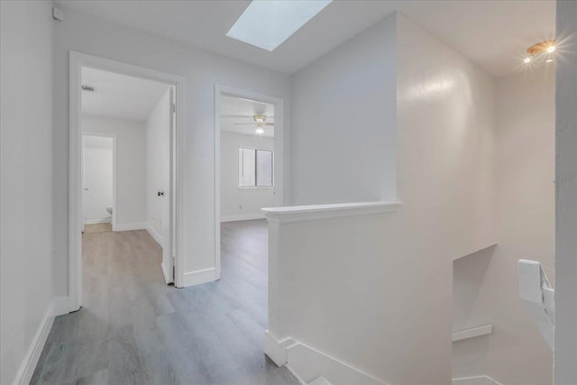 1317 Airport Dr Unit F12, Tallahassee, FL 32304 - hall with light wood-style floors, baseboards, an upstairs landing, and a skylight