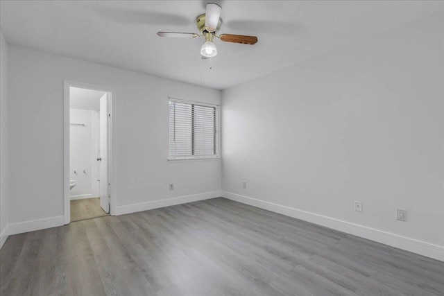 1317 Airport Dr Unit F12, Tallahassee, FL 32304 - unfurnished bedroom with baseboards, ceiling fan, ensuite bath, and wood finished floors