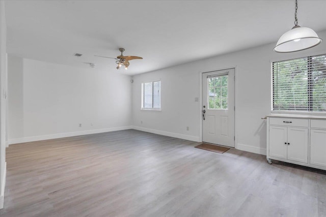 1317 Airport Dr Unit F12, Tallahassee, FL 32304 - unfurnished living room featuring baseboards, ceiling fan, and light wood finished floors