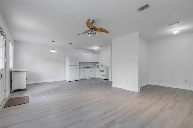 1317 Airport Dr Unit F12, Tallahassee, FL 32304 - unfurnished living room featuring visible vents, baseboards, ceiling fan, and light wood-style floors
