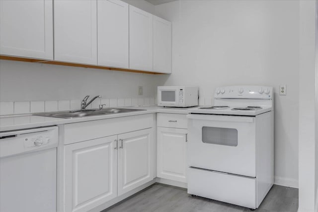 1317 Airport Dr Unit F12, Tallahassee, FL 32304 - kitchen featuring white appliances, white cabinets, a sink, and light wood-style flooring
