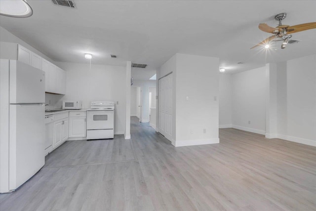 1317 Airport Dr Unit F12, Tallahassee, FL 32304 - kitchen with visible vents, white appliances, light countertops, white cabinetry, and a sink