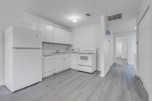 1317 Airport Dr Unit F12, Tallahassee, FL 32304 - kitchen with visible vents, white appliances, light countertops, white cabinets, and a sink