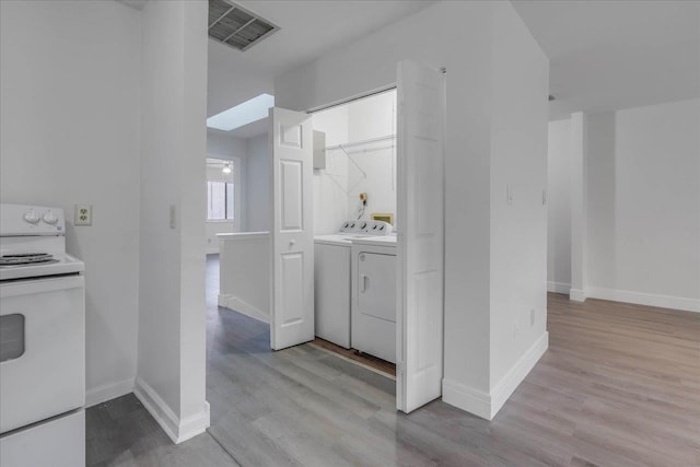1317 Airport Dr Unit F12, Tallahassee, FL 32304 - laundry area featuring laundry area, independent washer and dryer, visible vents, wood finished floors, and baseboards