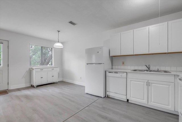 1317 Airport Dr Unit F12, Tallahassee, FL 32304 - kitchen featuring a sink, white appliances, light countertops, white cabinetry, and visible vents