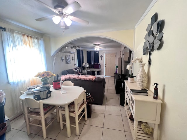 dining space with ceiling fan, light tile patterned floors, and crown molding