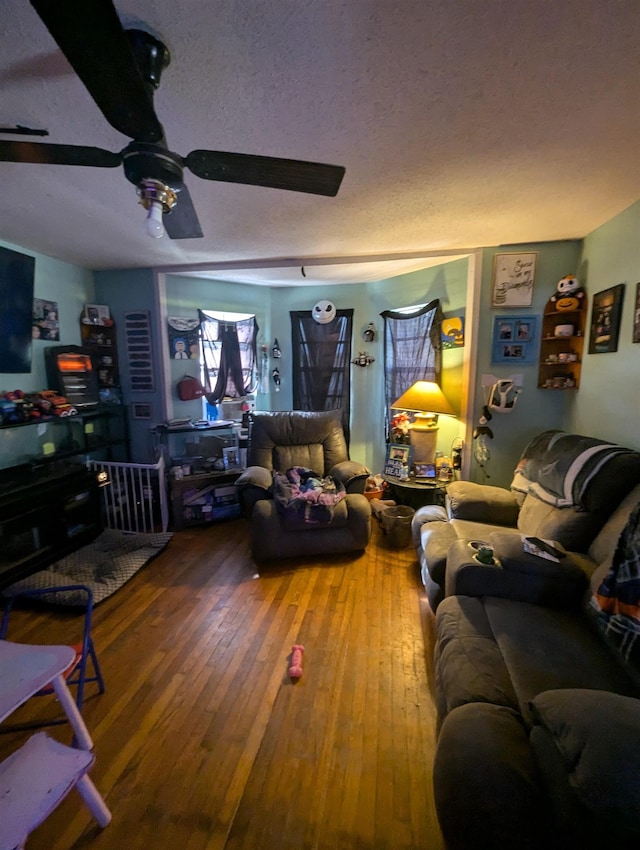 living room with wood-type flooring and a textured ceiling