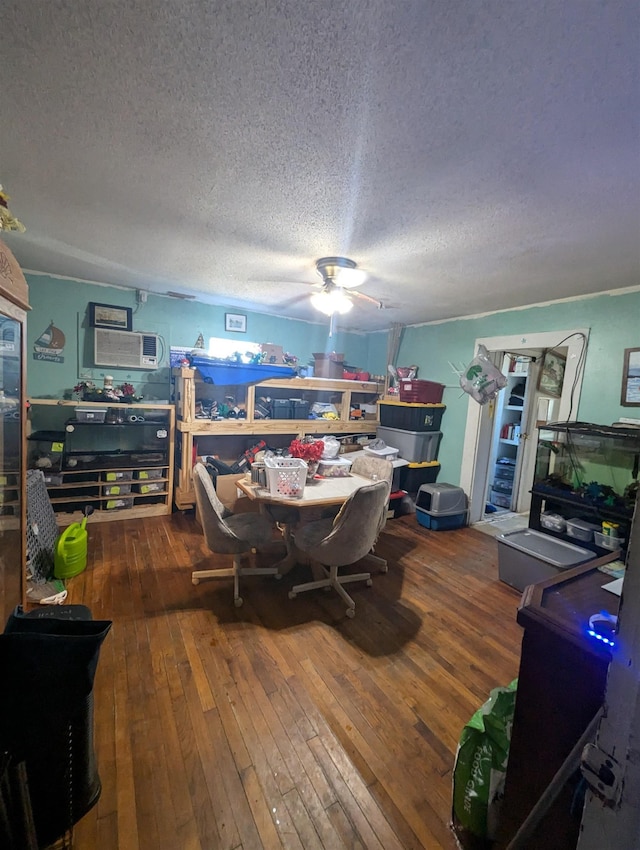 dining room with a textured ceiling and hardwood / wood-style flooring