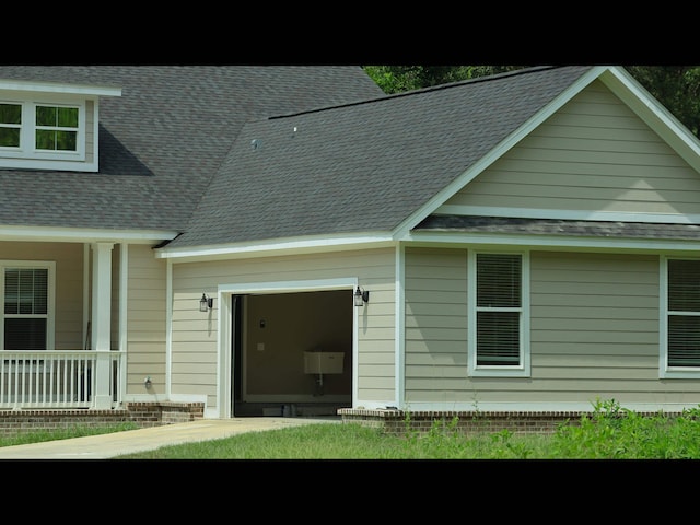 back of property with a porch