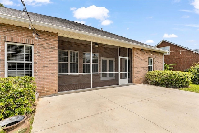 back of house with ceiling fan, a sunroom, and a patio area