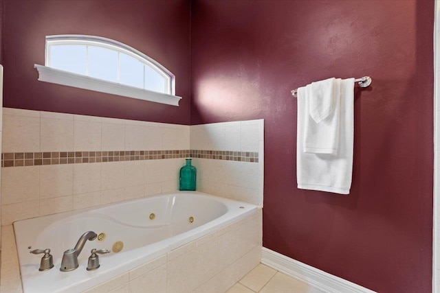 bathroom with tiled bath and tile patterned flooring