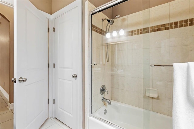 bathroom with tile patterned flooring and shower / bath combination with glass door