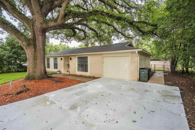 1553 Goodwood Dr, Tallahassee, FL 32308 - ranch-style house featuring brick siding, an attached garage, and driveway