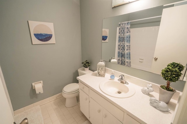 1553 Goodwood Dr, Tallahassee, FL 32308 - full bath featuring toilet, vanity, a shower with shower curtain, tile patterned flooring, and baseboards