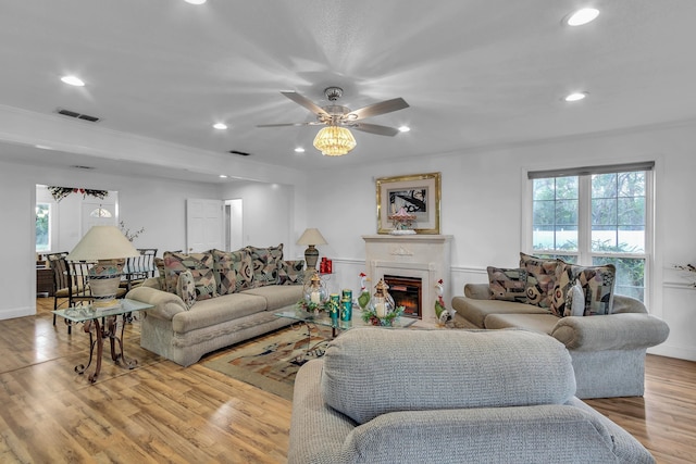 living room featuring wood-type flooring, a wealth of natural light, and ceiling fan