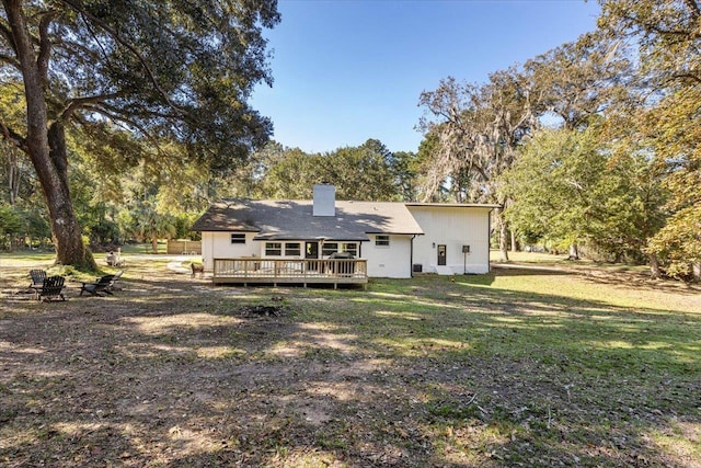 back of property featuring a yard and a deck