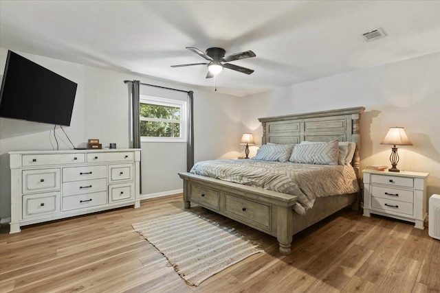 bedroom with light hardwood / wood-style flooring and ceiling fan