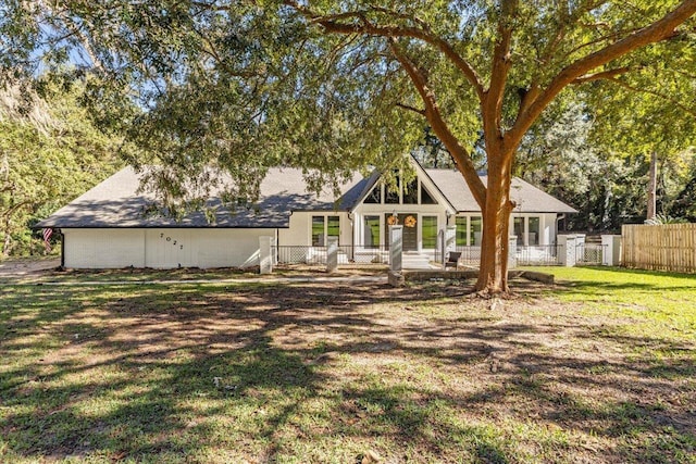 rear view of property with a yard