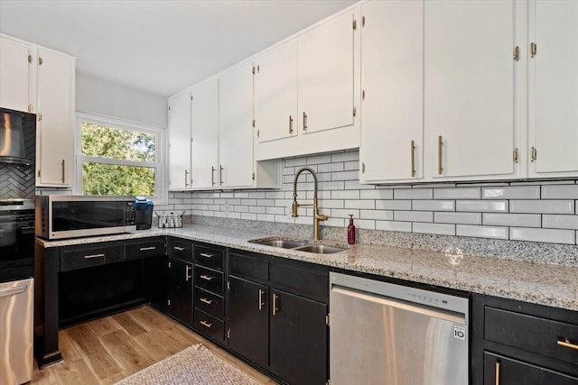 kitchen featuring stainless steel appliances, sink, and white cabinets