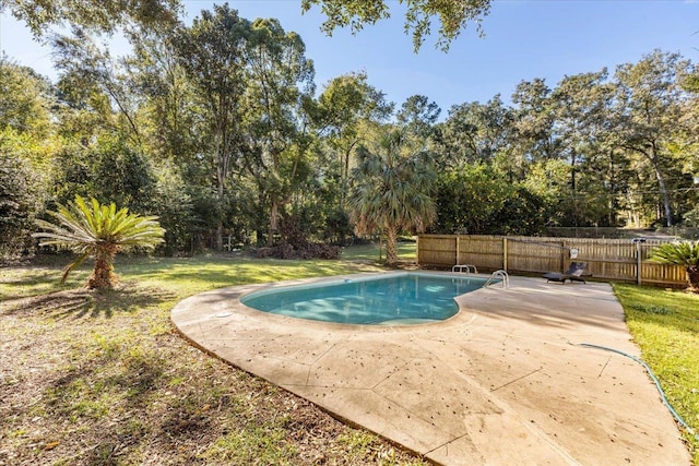 view of pool with a patio area and a lawn