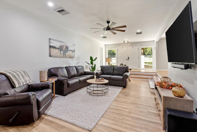 living room with ceiling fan and light hardwood / wood-style floors