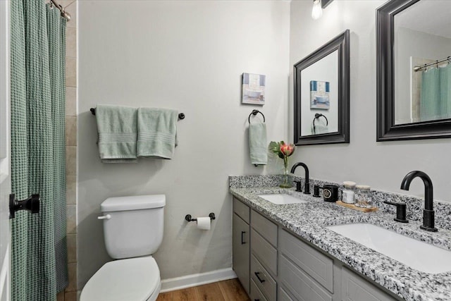 bathroom with vanity, toilet, a shower with shower curtain, and wood-type flooring