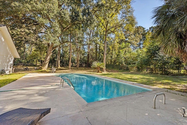 view of pool with a yard and a patio area