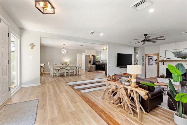 interior space with ceiling fan and light hardwood / wood-style floors